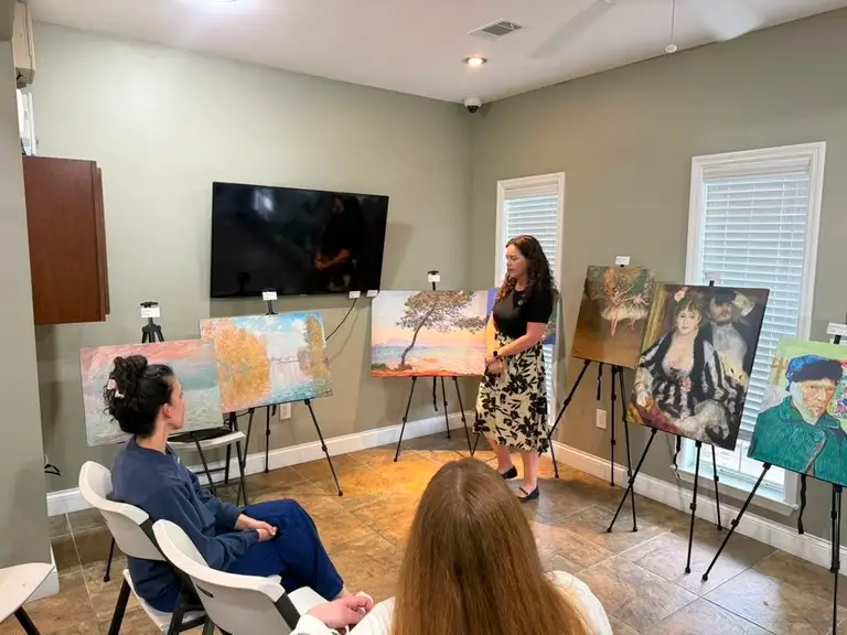 DOCENT interactive presentation — life-size art replicas on easels with an engaged audience